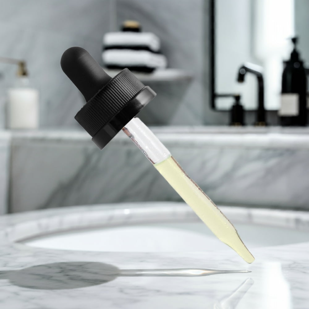 The dropper from a bottle of Moisturizing and Strengthening Hair Oil from World's Best Supplements.