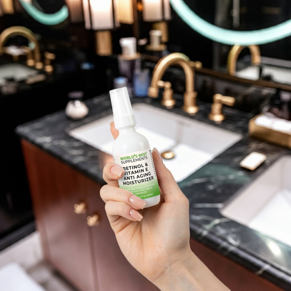 A woman's hand holding a bottle of Retinol & Vitamin E Anti-Aging Moisturizer from World's Best Supplements.