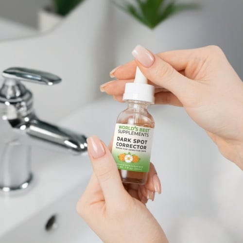 A lady's hands holding a bottle of Dark Spot Corrector Serum for Sensitive Skin by World's Best Supplements in 1 oz size.