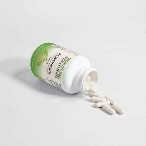 A bottle of Resveratrol 600mg with the capsules pouring onto a table from World's Best.