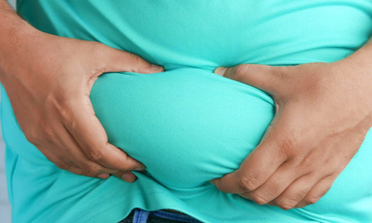 A blog post about the Best Gut Health Supplements in 2025, image of a man holding his belly 