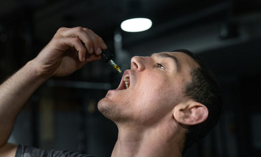 A healthy adult man taking supplement drops while intermittent fasting.