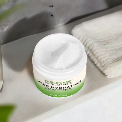 Looking down at a container of Deep Hydration Face & Body Cream container with he lid off on a bathroom counter.