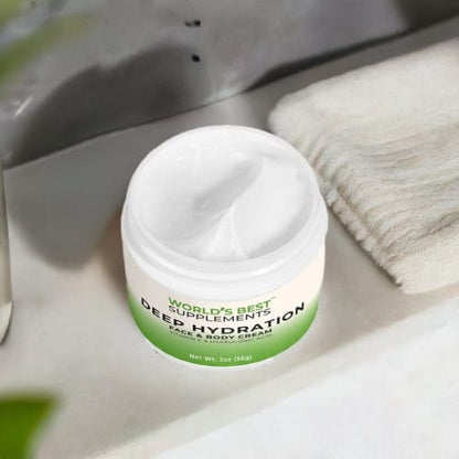 Looking down at a container of Deep Hydration Face & Body Cream container with he lid off on a bathroom counter.