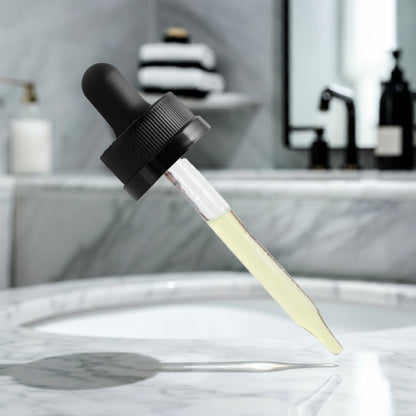 The dropper from a bottle of Moisturizing and Strengthening Hair Oil from World's Best Supplements.